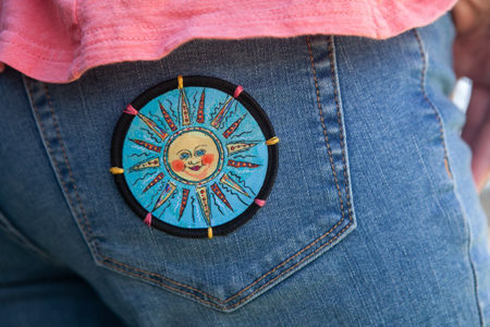 Sun Patch on jeans by Mary Butler